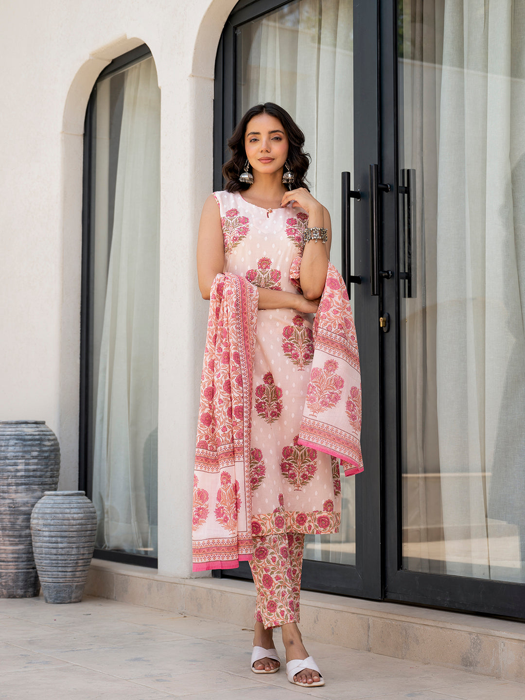 Woman in a pink floral printed cotton kurta pant set with matching dupatta