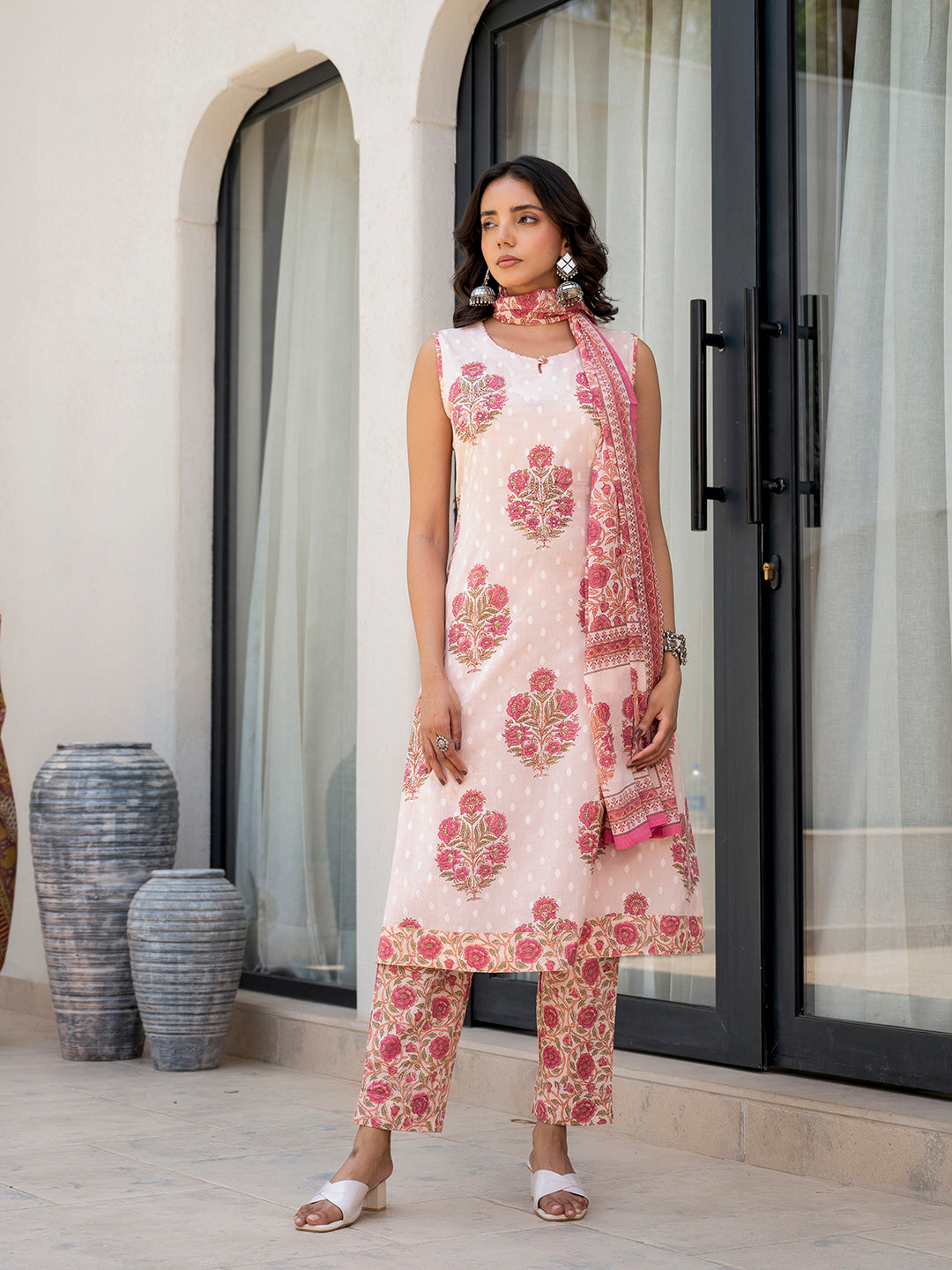 Woman in a pink floral printed cotton kurta pant set showcasing elegant design