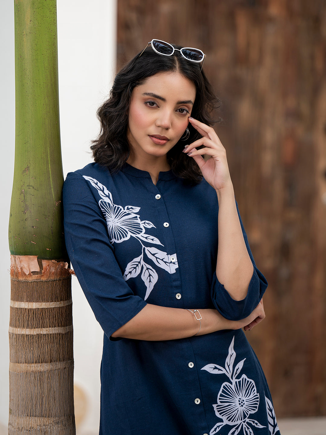 Woman in navy blue floral printed cotton A-line fit kurta pant set with white embroidery