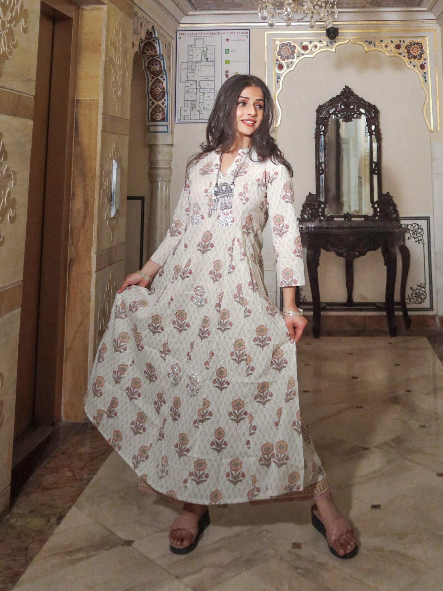 Woman in long white floral print cotton kurti with palazzo set and bell sleeves