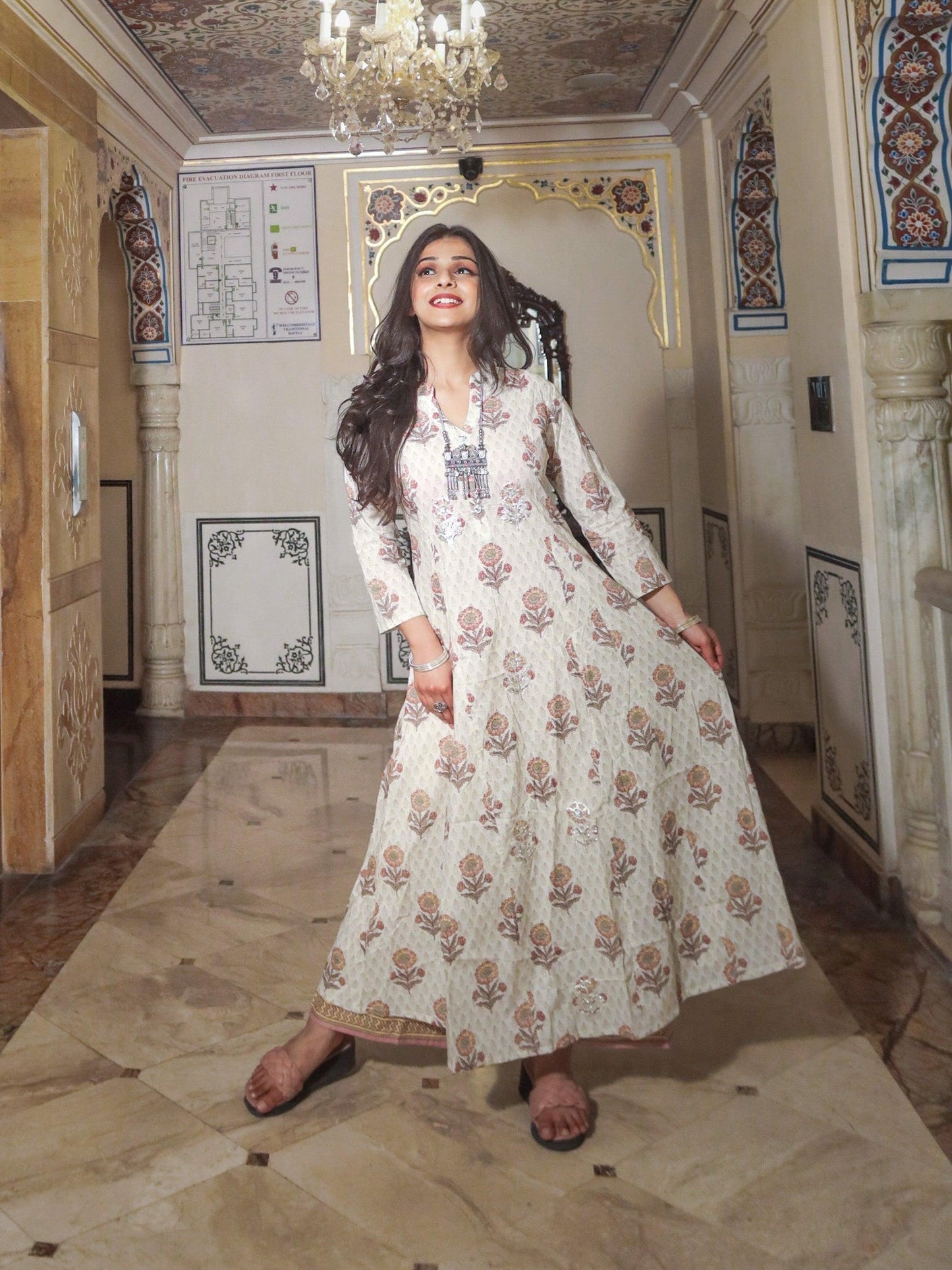 Woman in long white floral dress showcasing Ivory White Self Print Cotton Kurti with Palazzo Set