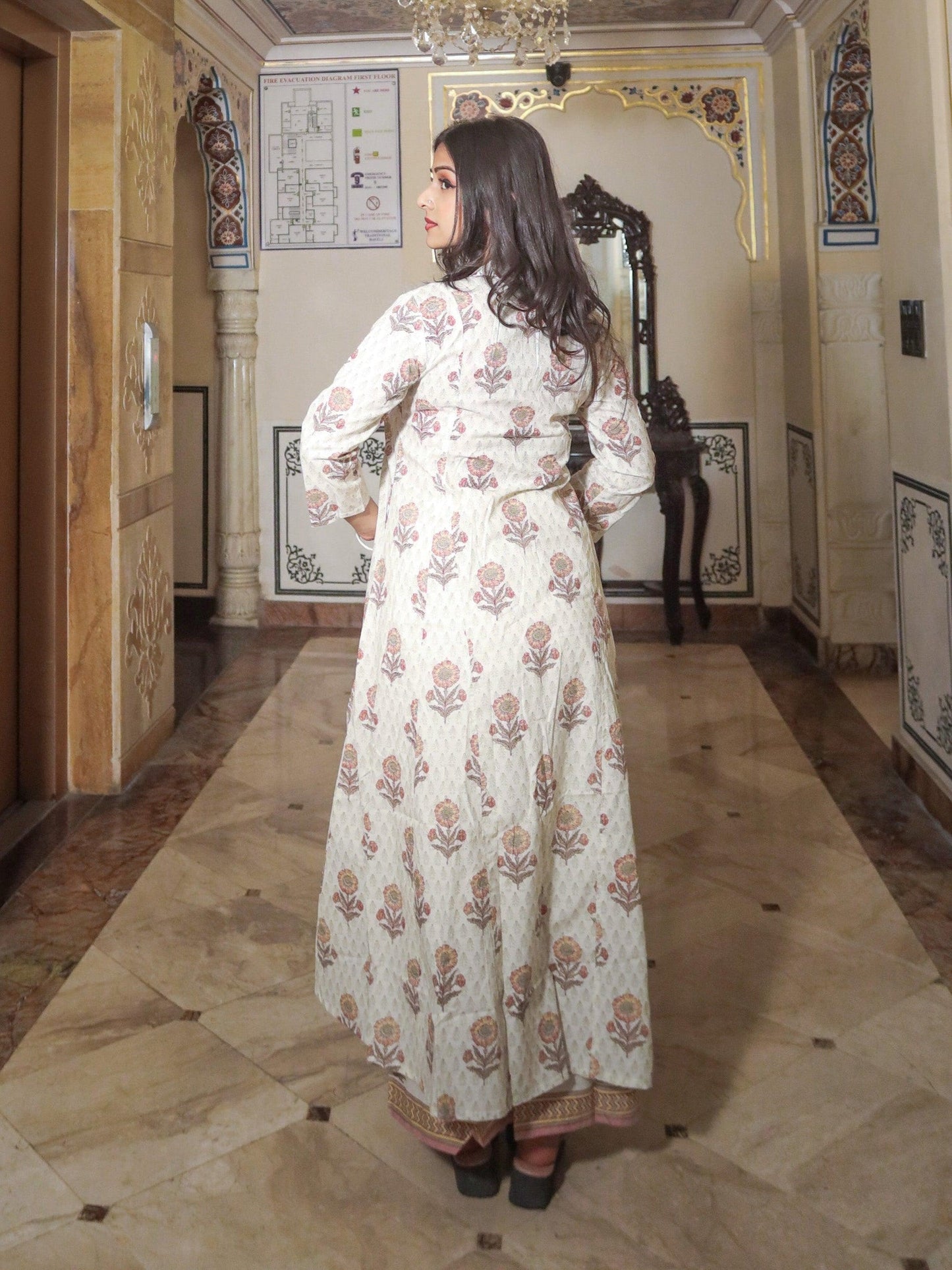 Woman in Ivory White Self Print Cotton Kurti with Palazzo Set, showcasing floral design