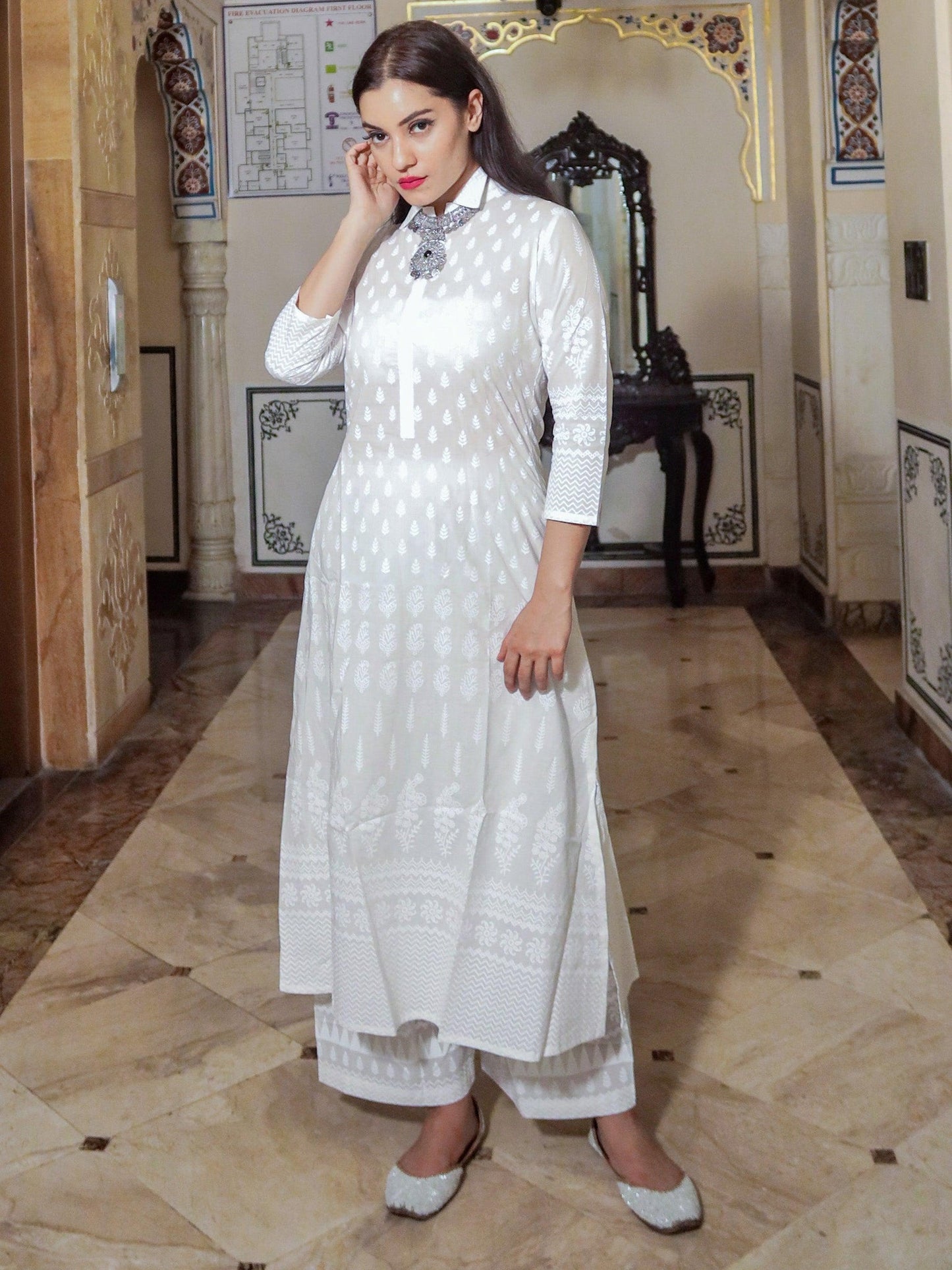 Woman in white Khari print cotton kurti with palazzo set, highlighting elegant embroidery