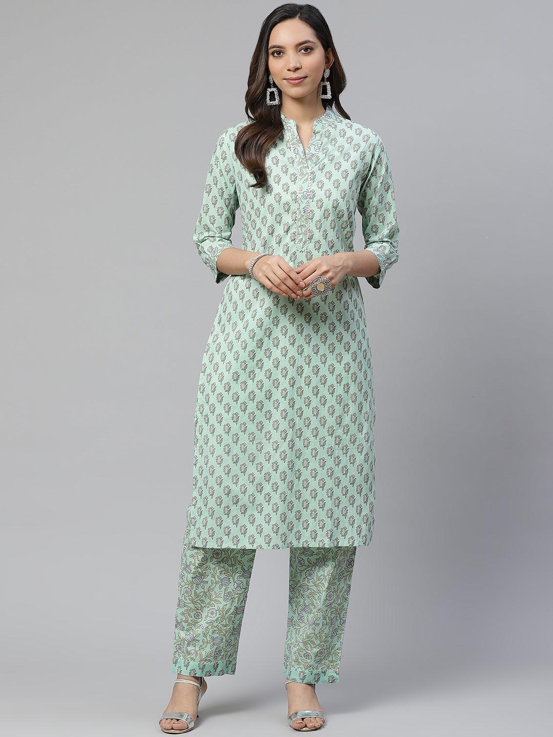 Woman wearing a Sea Green Cotton Printed Kurti Pant Set with mint green and white patterns