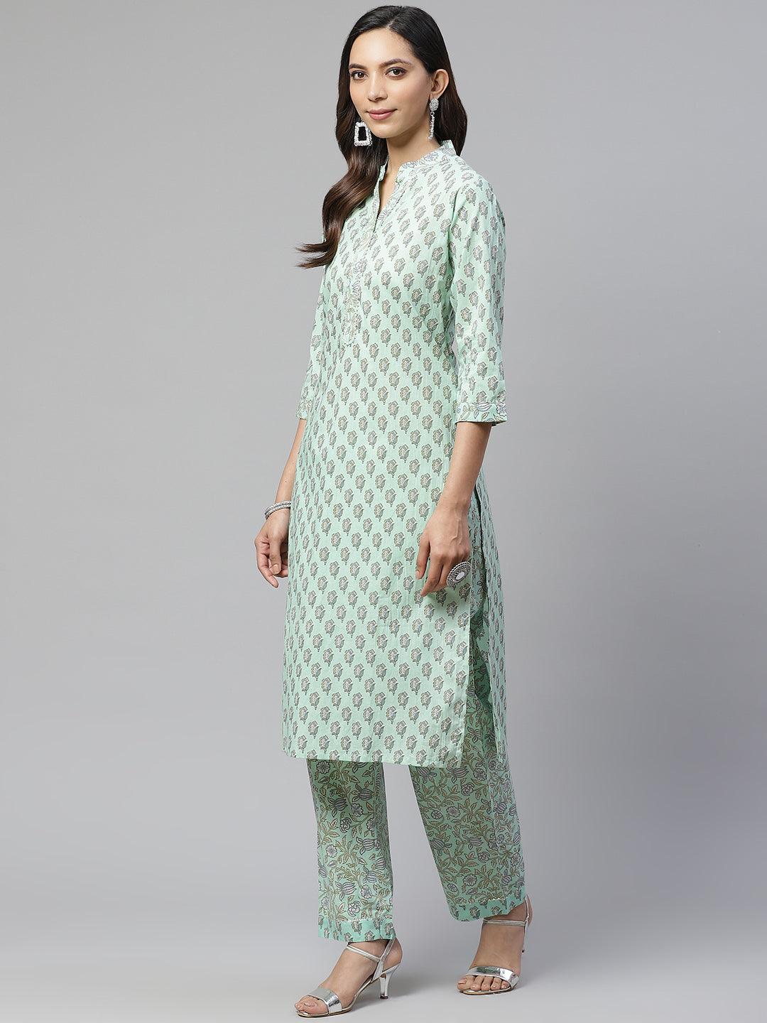 Woman wearing a Sea Green Cotton Printed Kurti Pant Set with mint green and white patterns