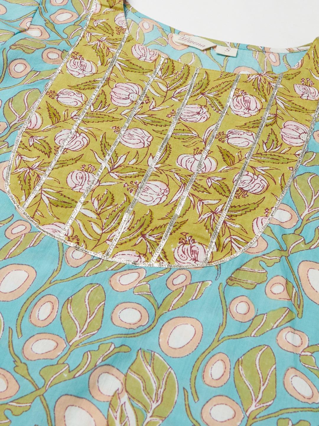 Sky blue floral patterned fabric featuring vibrant green, pink, and blue designs