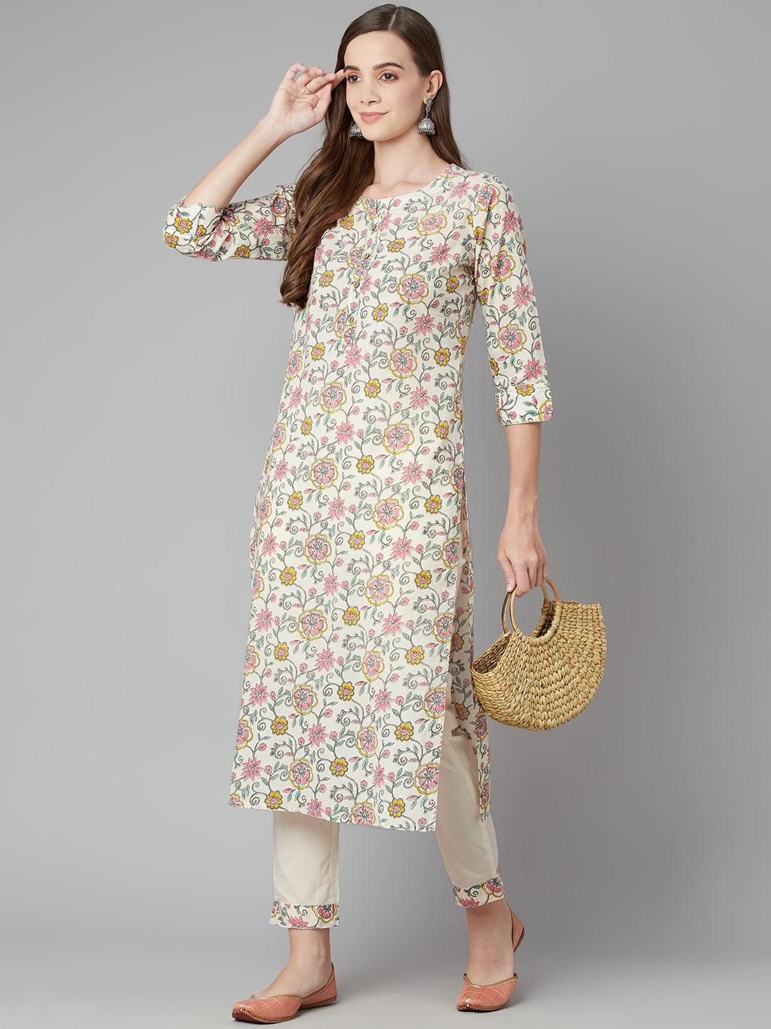 Woman in a floral printed cotton kurta pant set with three-quarter sleeves and woven handbag