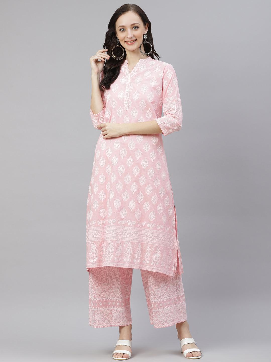 Pink floral printed kurta and palazzo set worn by a smiling woman.