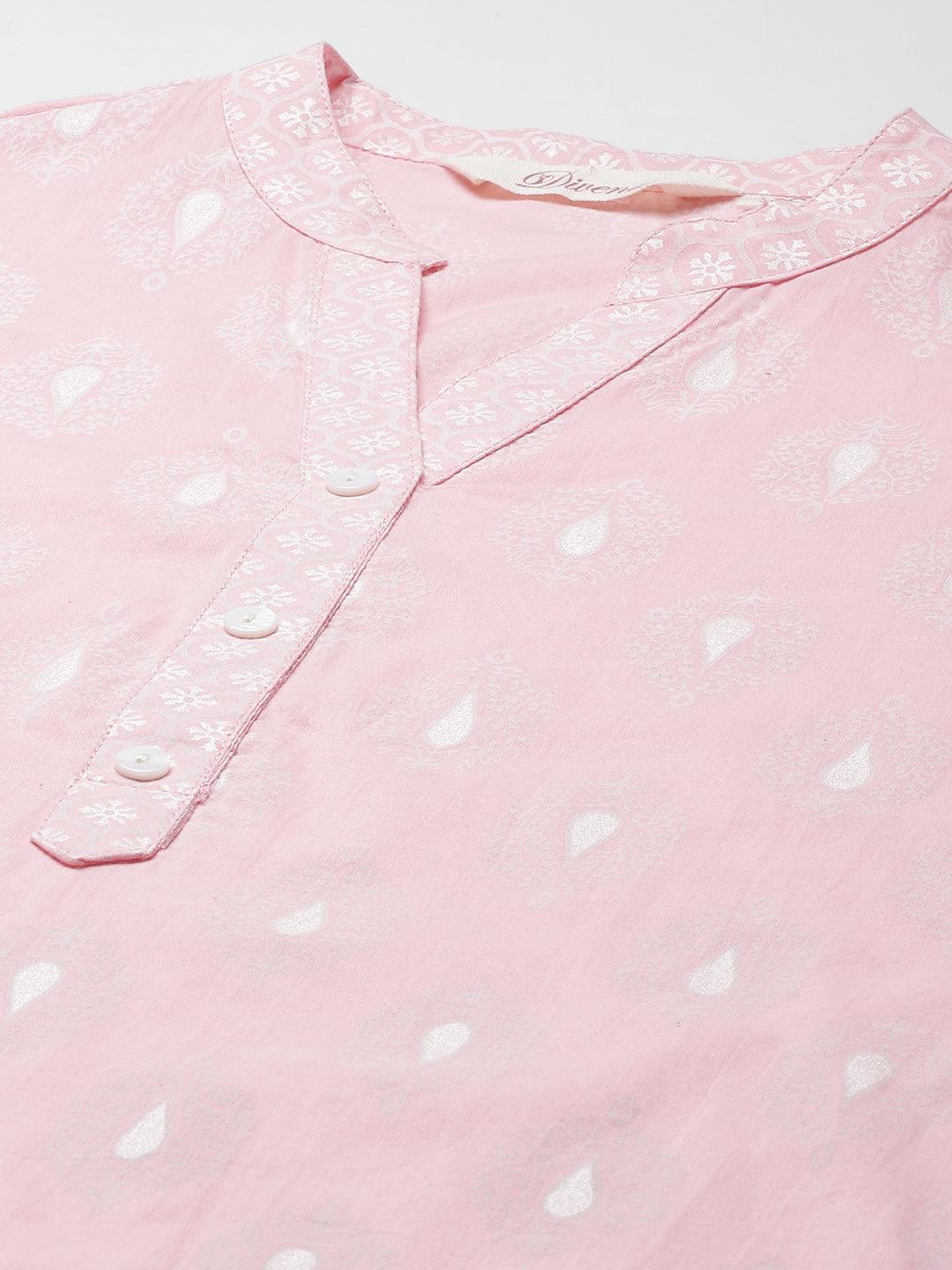 Pink polka dot baby onesie with button placket.