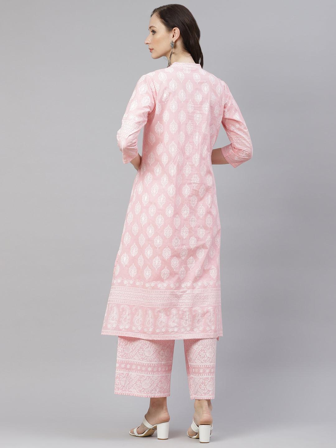 Pink and white patterned kurta and pants set worn by a woman facing away from the camera.