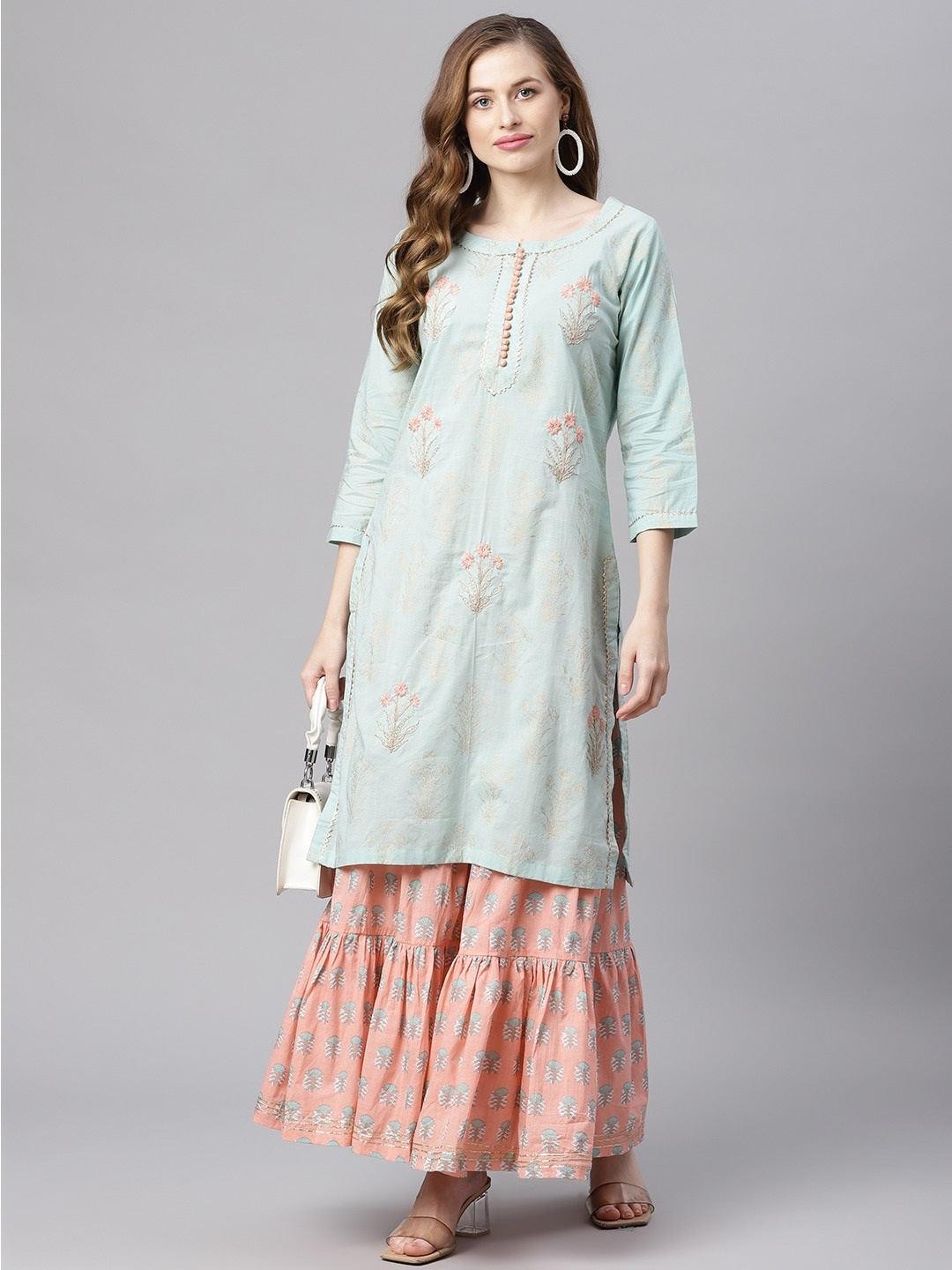 Woman in light blue floral cotton kurta sharara set over a pink floral skirt