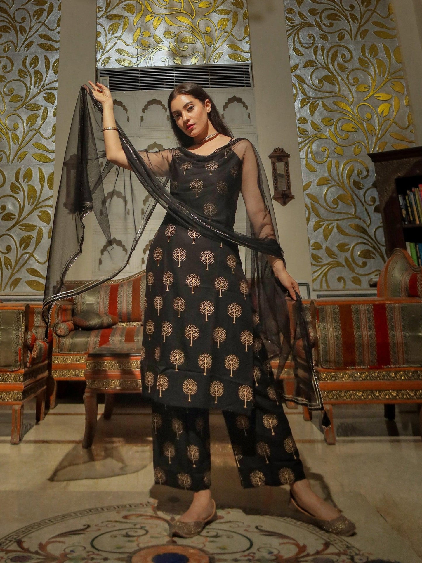 Woman in a Black Golden Foil Printed Shoulder Strip Kurta Palazoo Set outfit