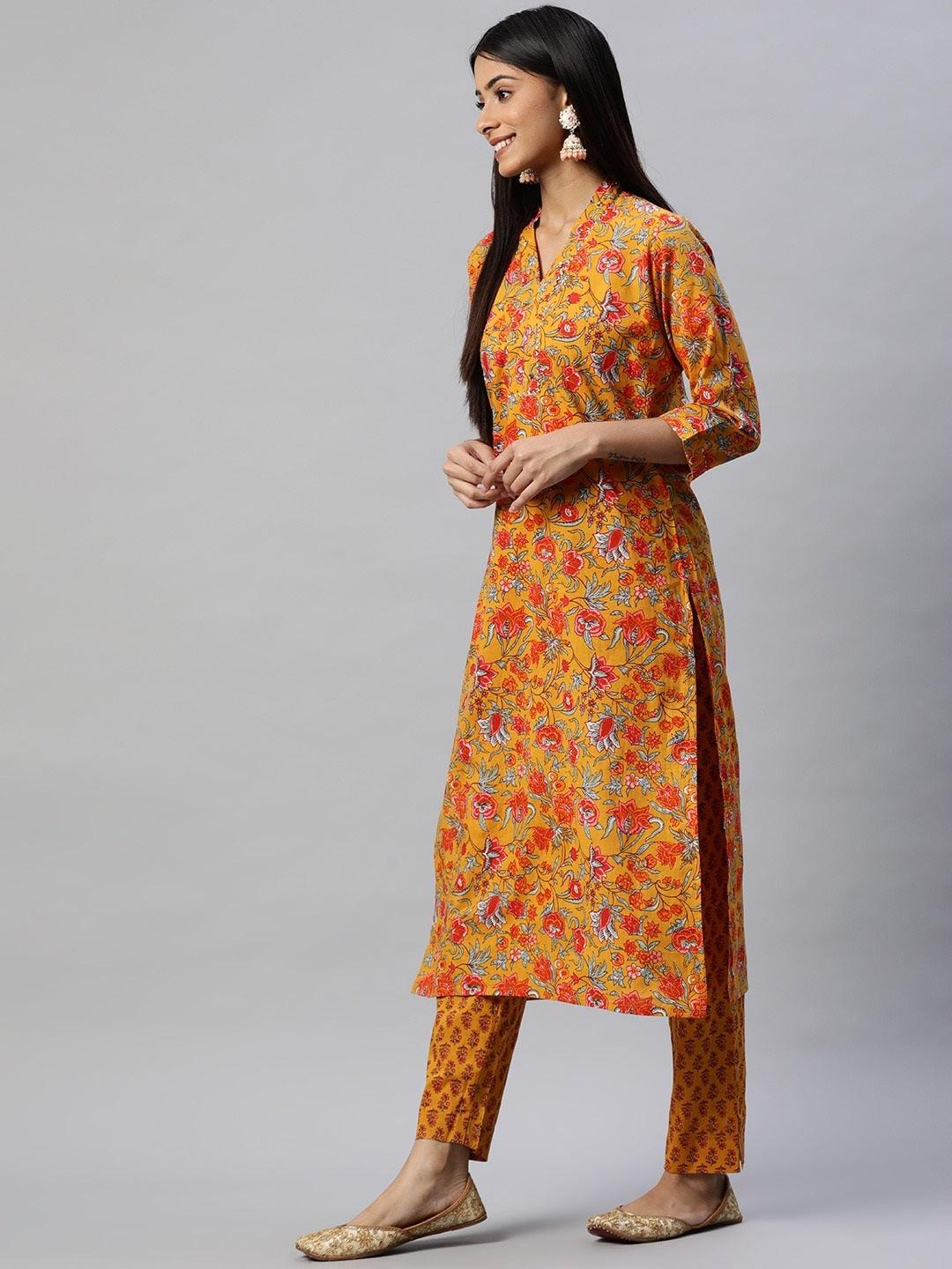 Floral printed kurta pant set in mustard cotton worn by a woman with dark hair