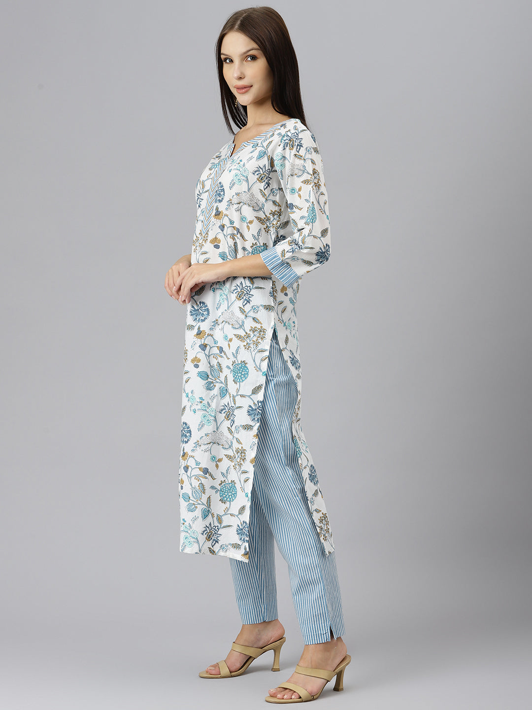 Woman in a Floral Printed Pure Cotton Kurta over Light Blue Striped Pants