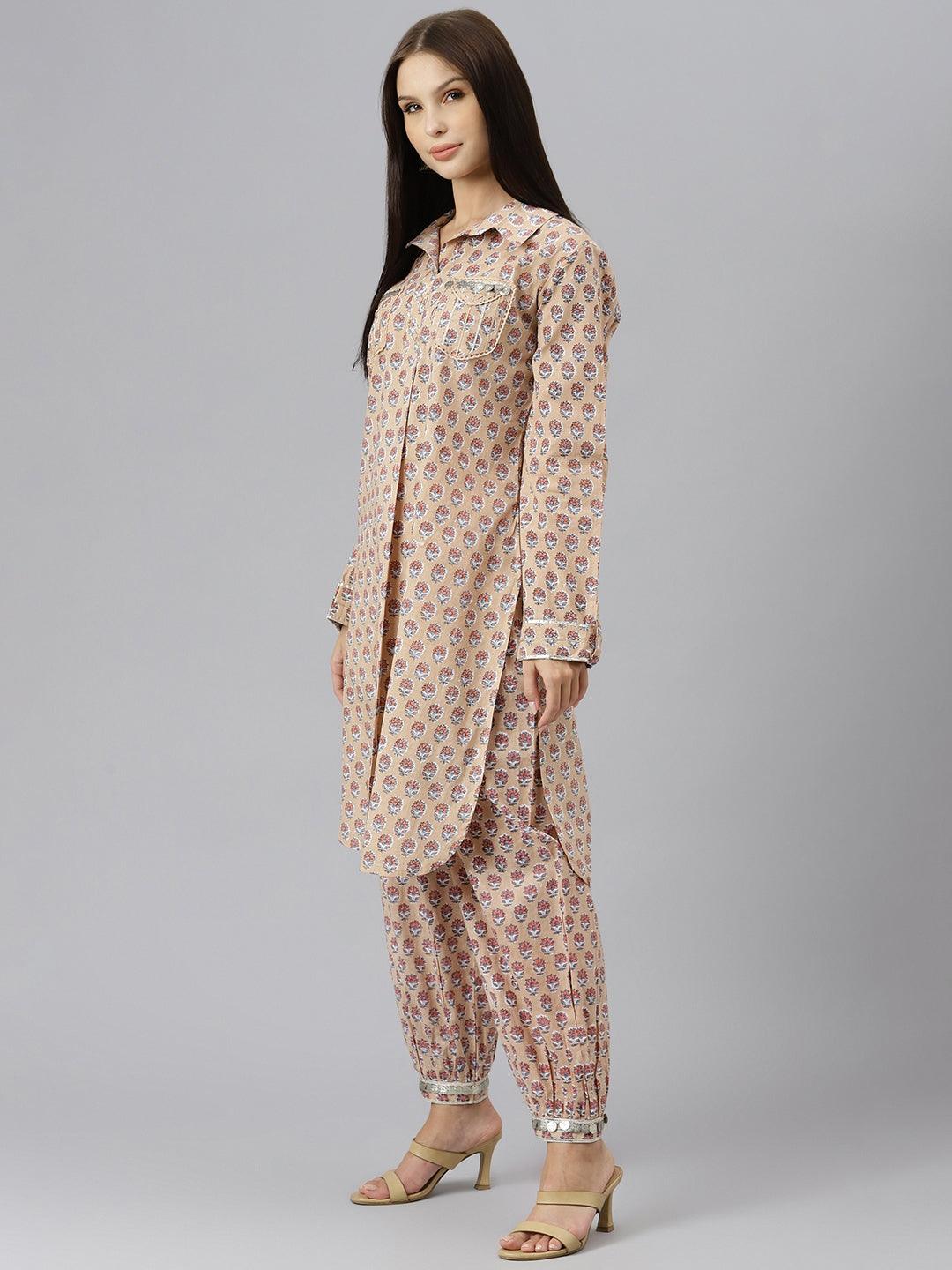 Woman in a beige and pink floral print shirt style kurta and cuffed pant co-ord set