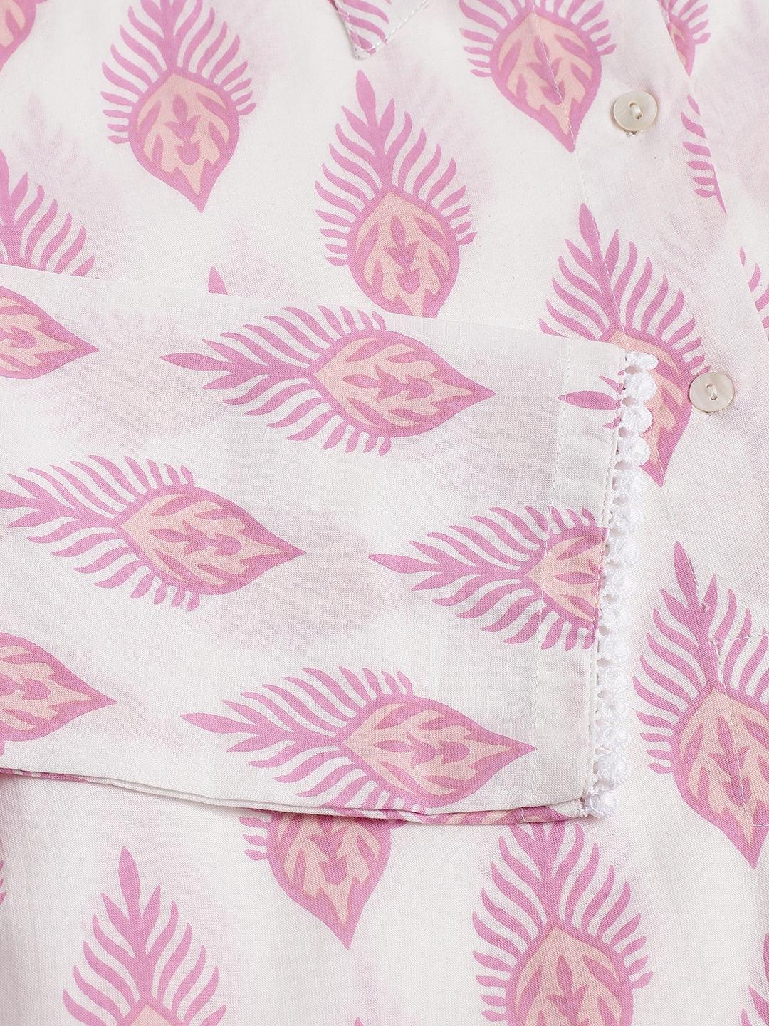 Pink leaf-patterned fabric showcasing a button on the White Cotton Straight Kurta Hem Cuffed Pant set