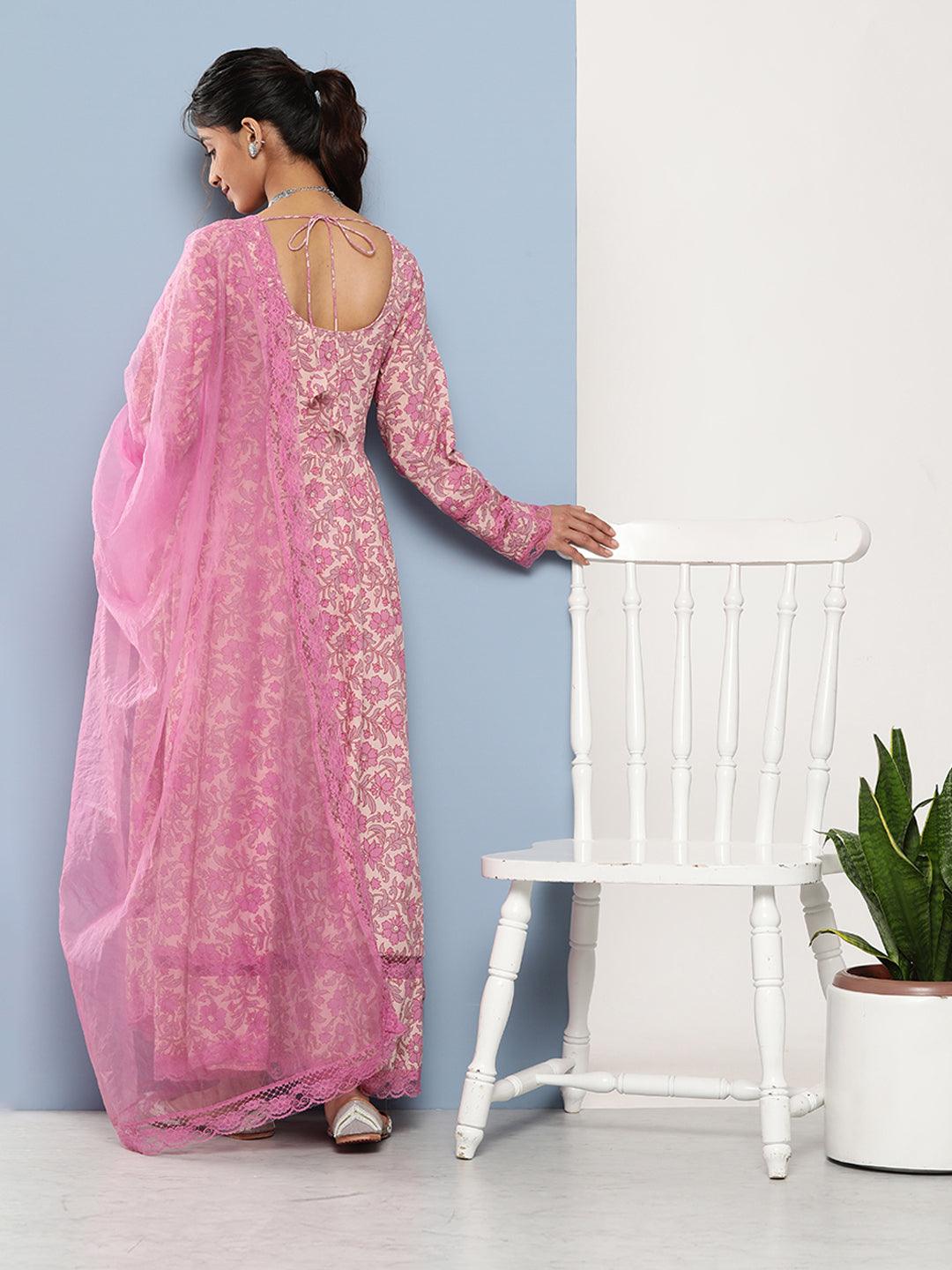 Woman in Pink Lace Sari by White Chair with Lilac Floral Printed Anarkali Kurta Pant Set