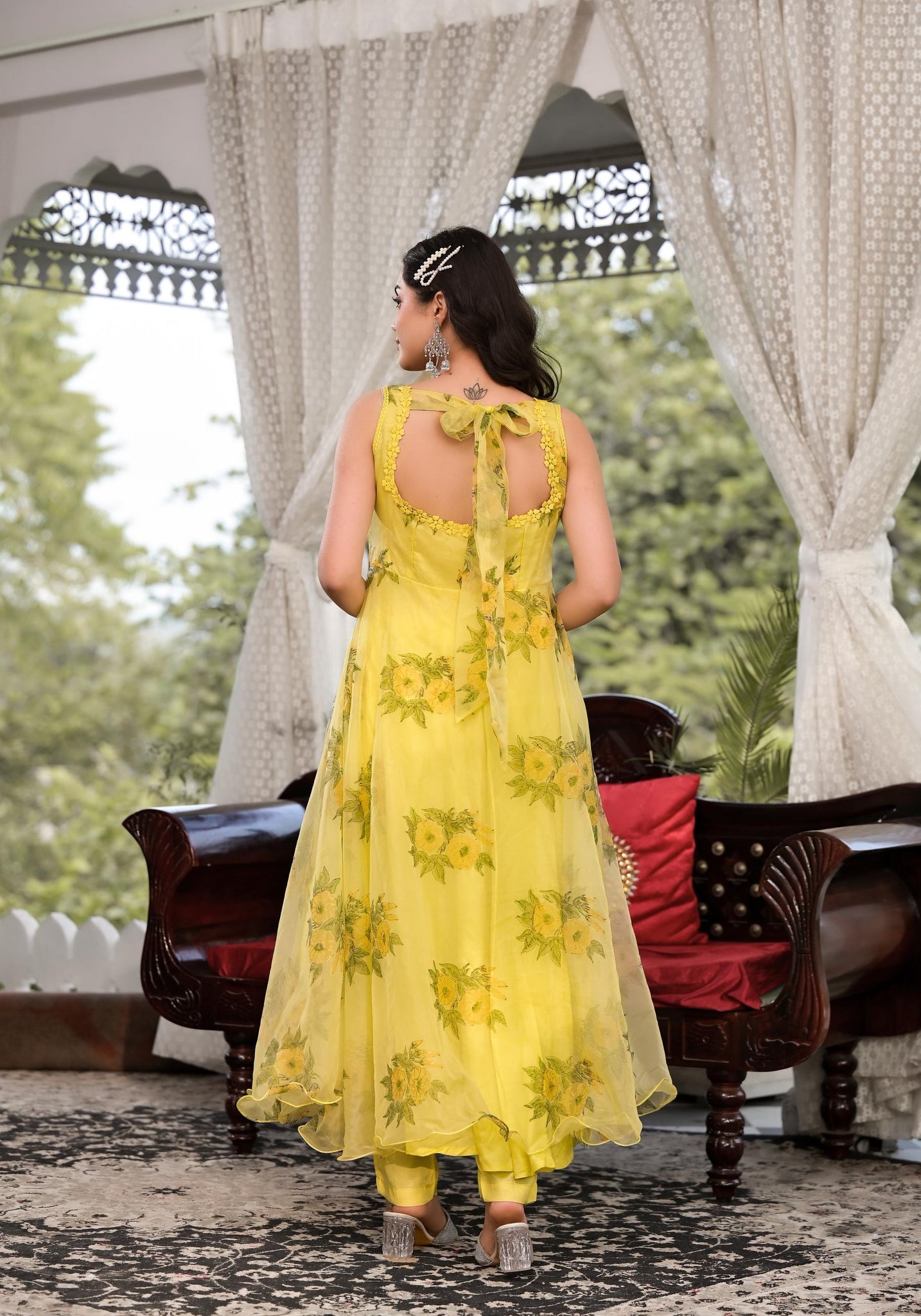 Woman in a Light Yellow Hand Painted Floral Organza Anarkali Kurta with Sheer Back