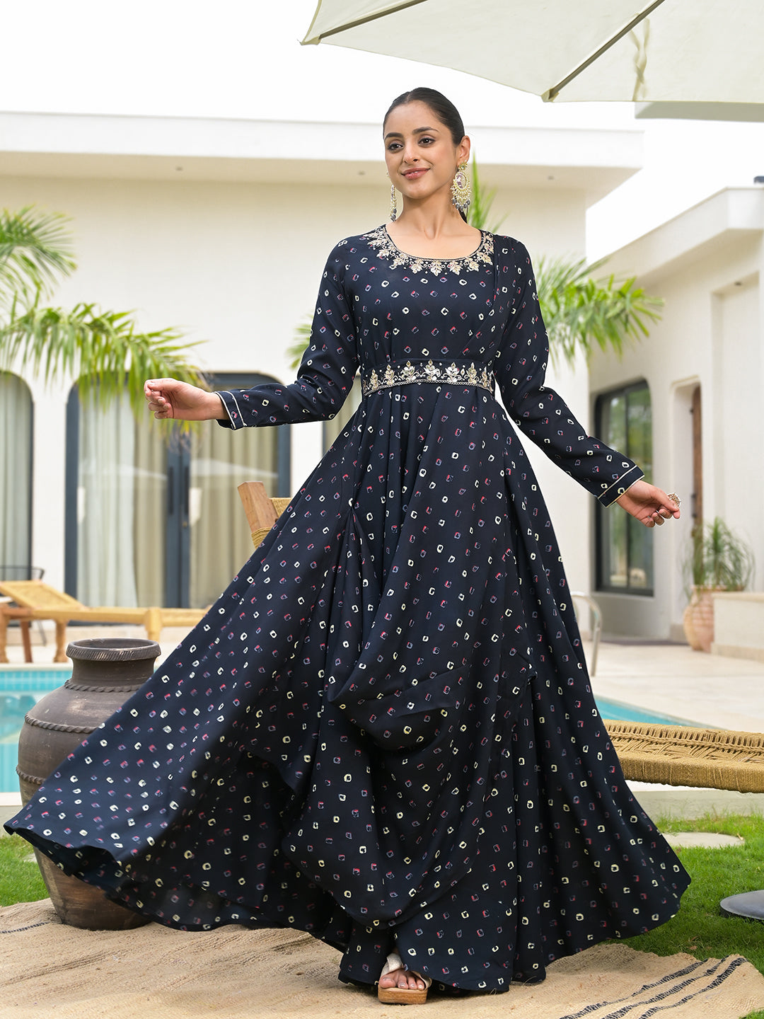 Long flowing navy blue Bandhani print dress with white polka dots and embellished belt