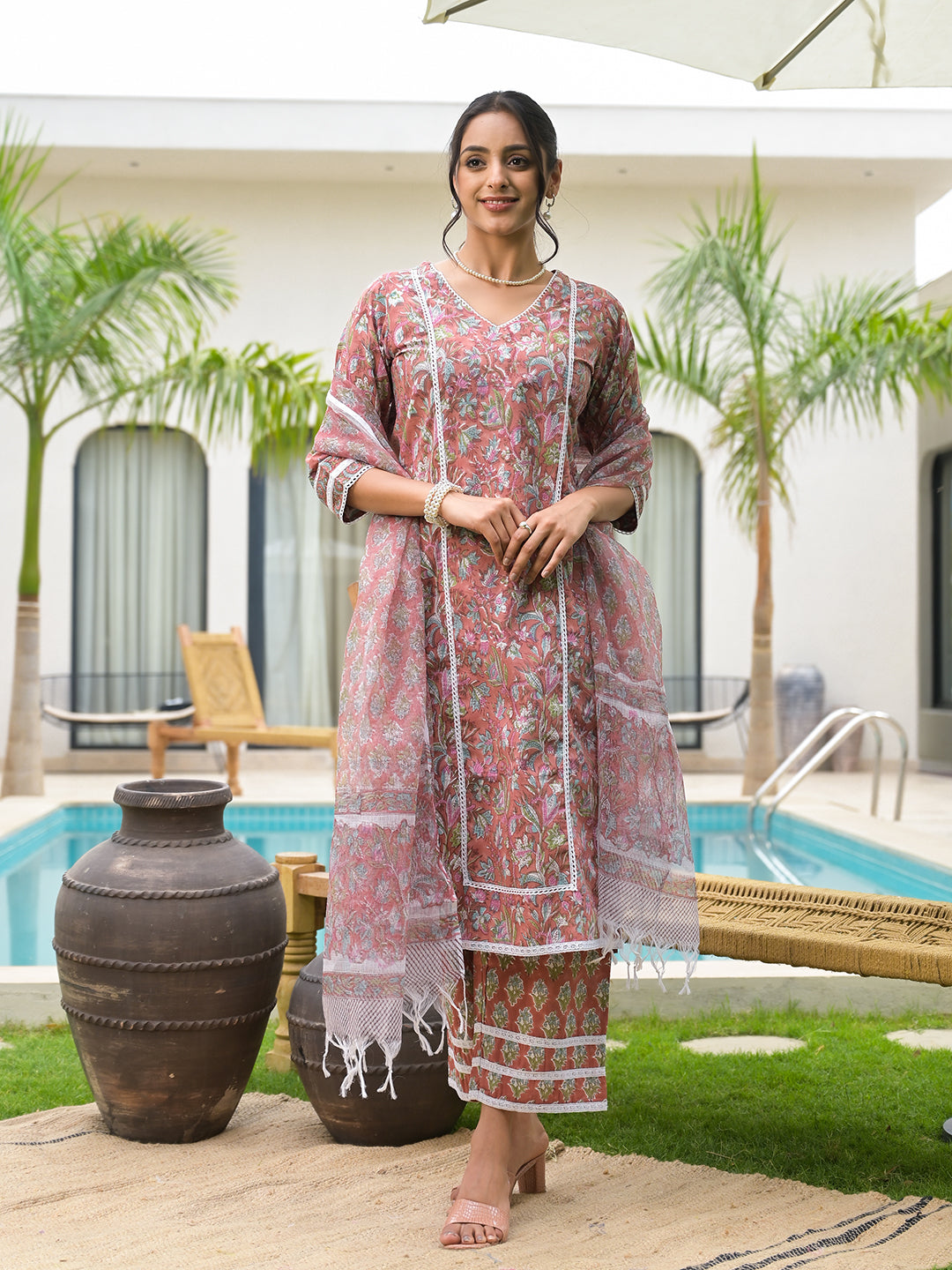 Woman in a pink floral embroidered salwar kameez from a Maroon Floral Print Cotton Handblock Kurta Set