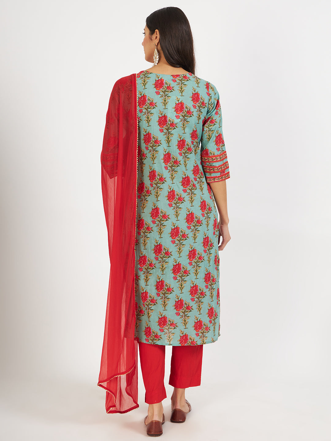 Woman in green floral print cotton kurta with red pants and matching dupatta