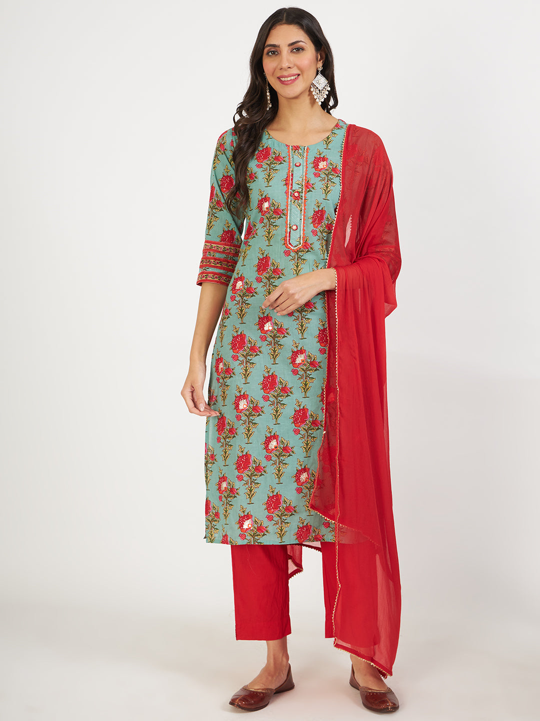 Woman in a green floral print cotton kurta for women with red pants and dupatta