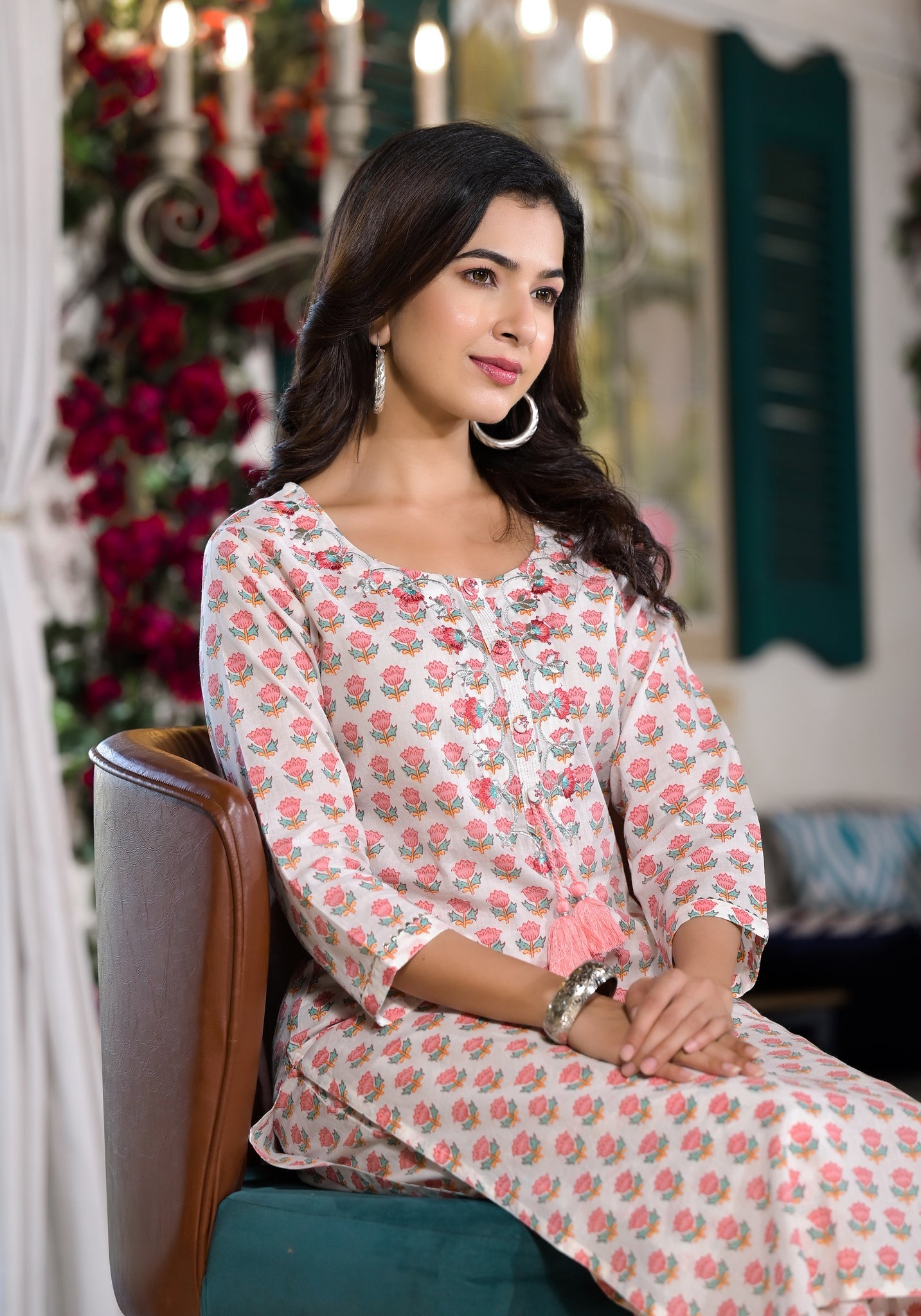 Woman in a pink floral printed cotton kurta with trouser and hoop earrings