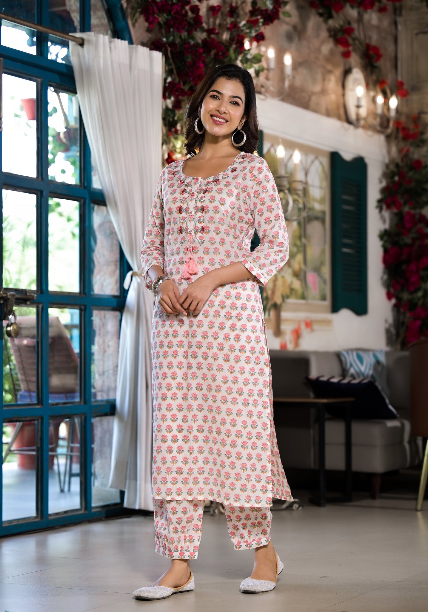 Woman in a pink floral printed cotton kurta with trouser showcasing Unicorn Fashion