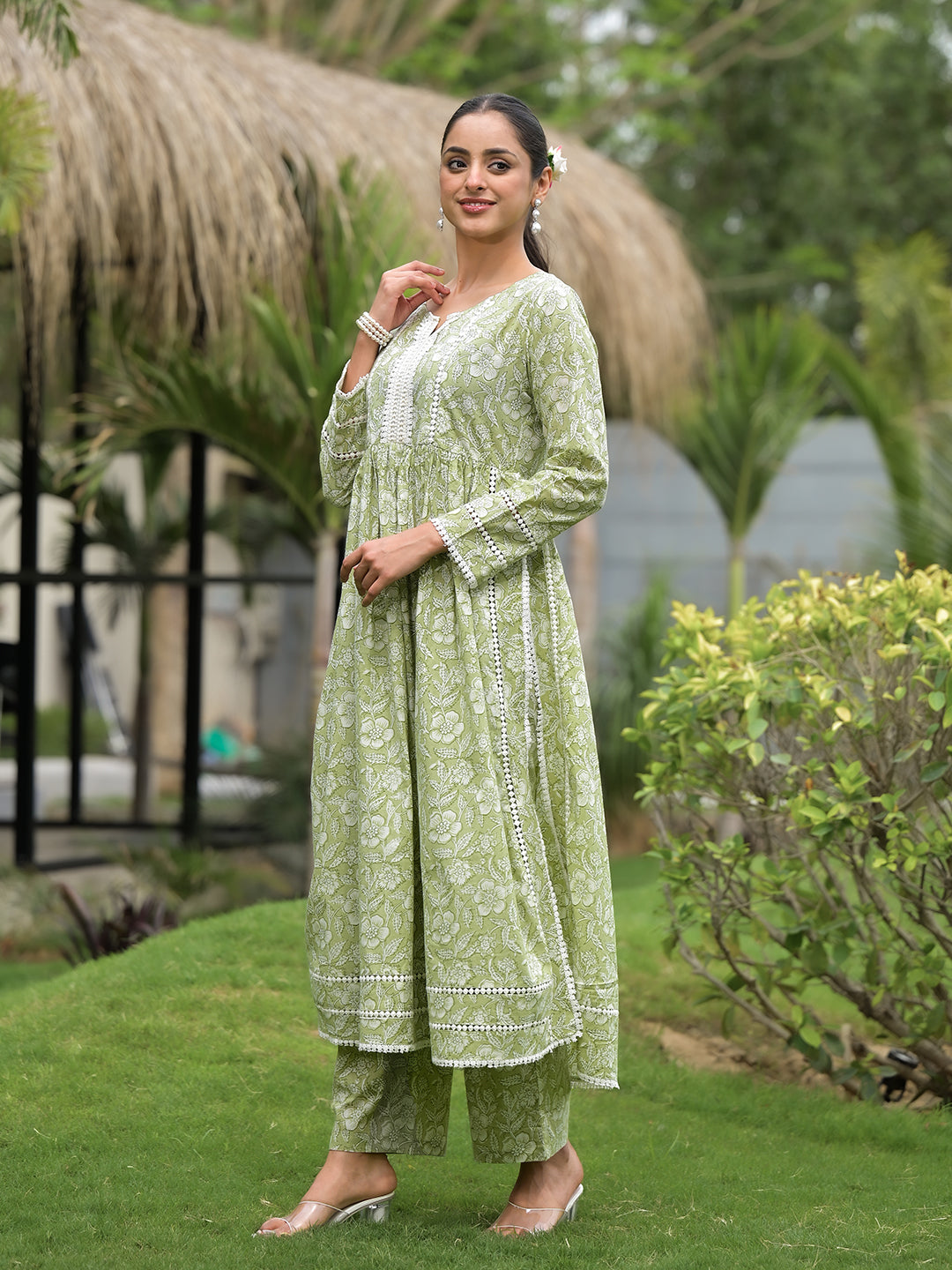 Light green floral print cotton Nyra Cut Kurta Pant Set styled on a woman