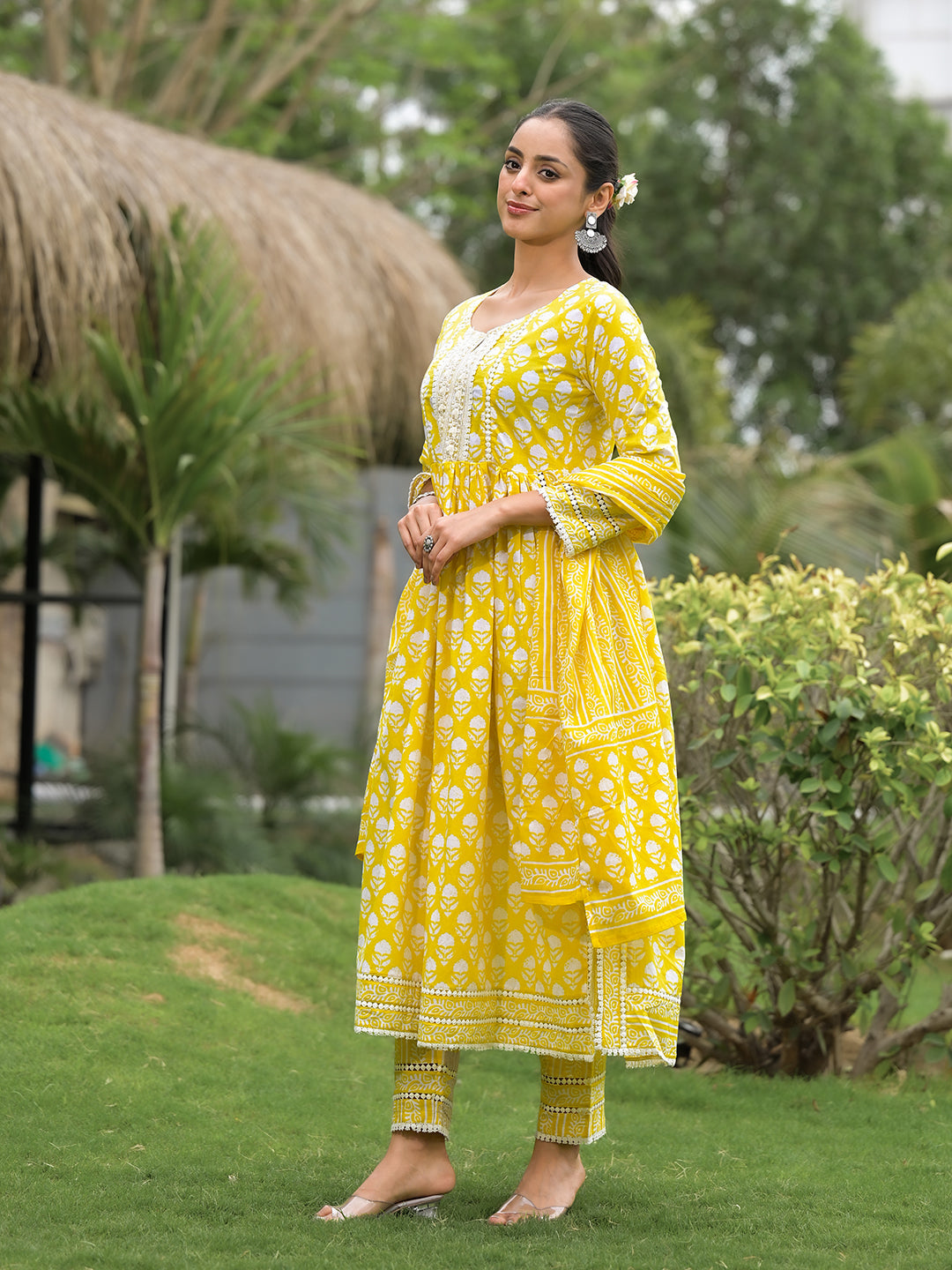 Bright yellow floral print cotton kurta pants ensemble worn by a woman