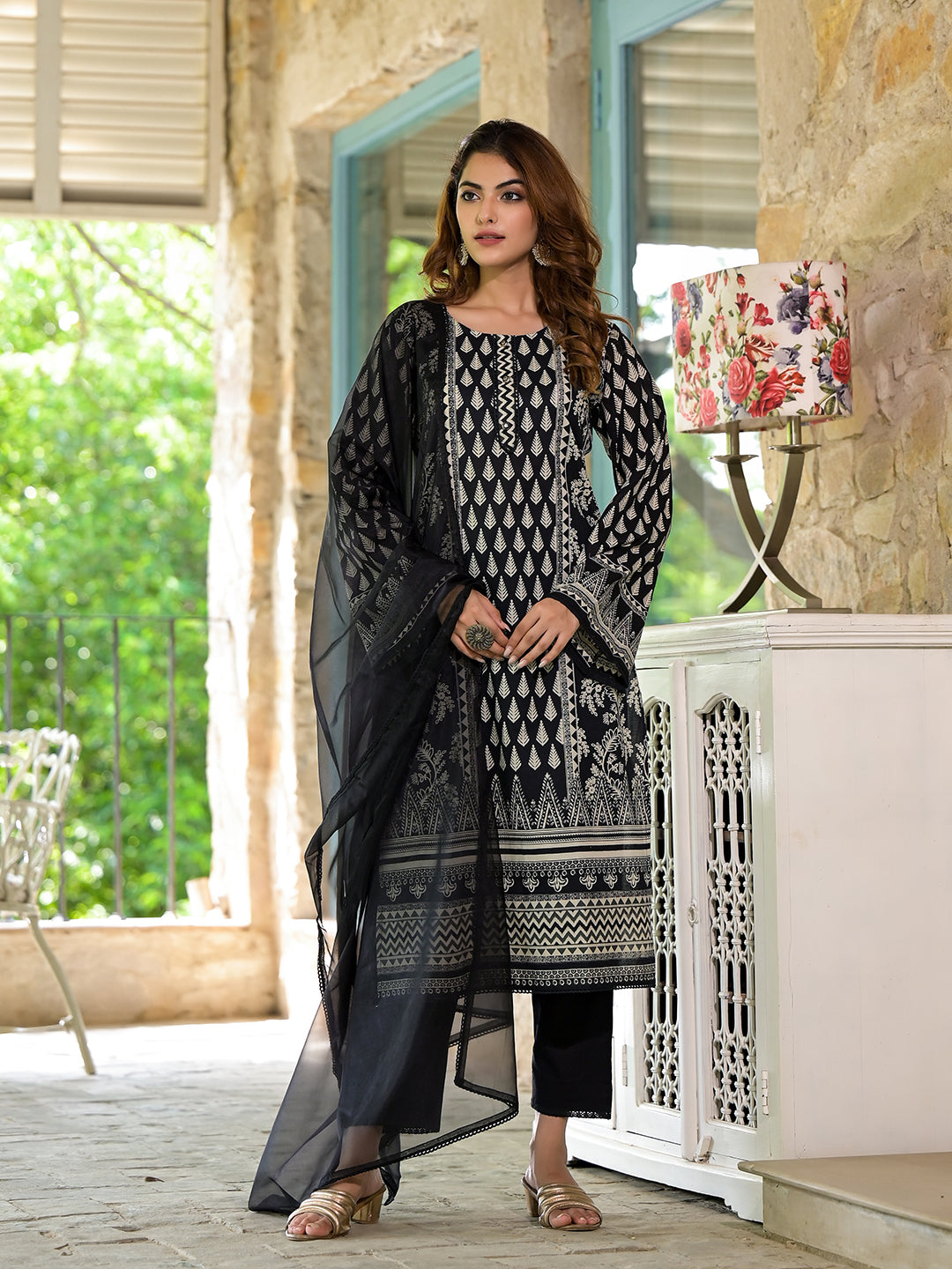 Woman in an elegant black cotton straight fit knee long kurta set for women