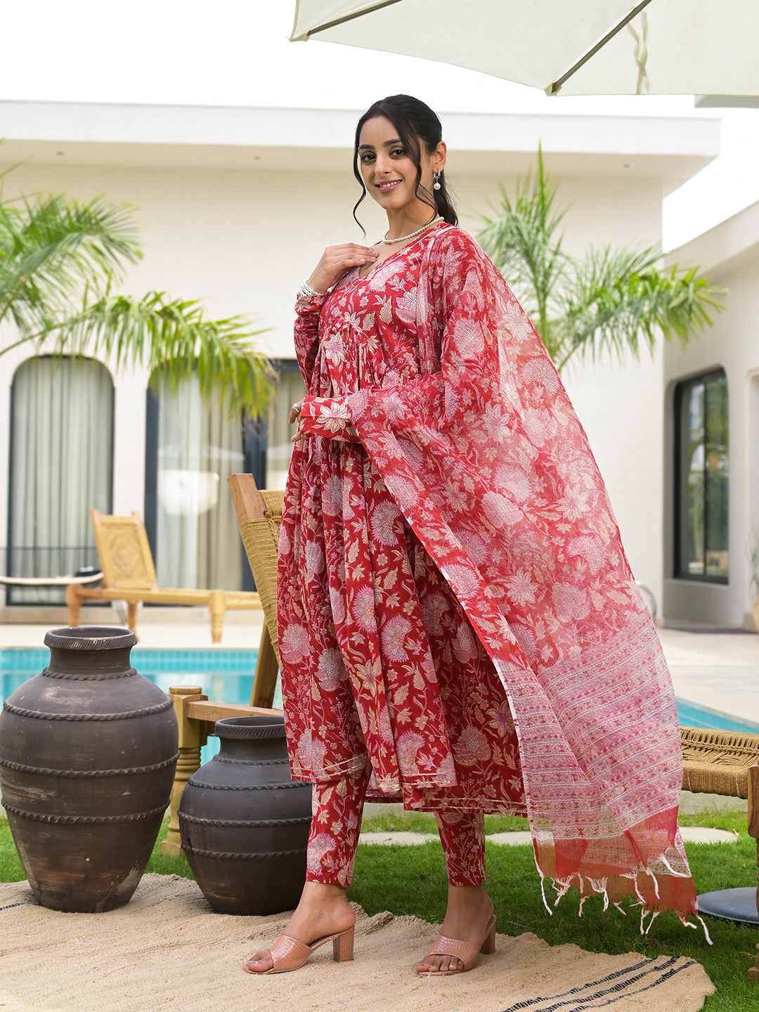 Woman in a Floral Printed Red Cotton Alia Cut Kurta Set showcasing vibrant patterns