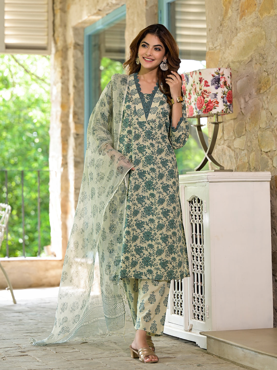 Woman in a Bottle Green Floral Print Cotton Kurta Set for Women with a flowing dupatta