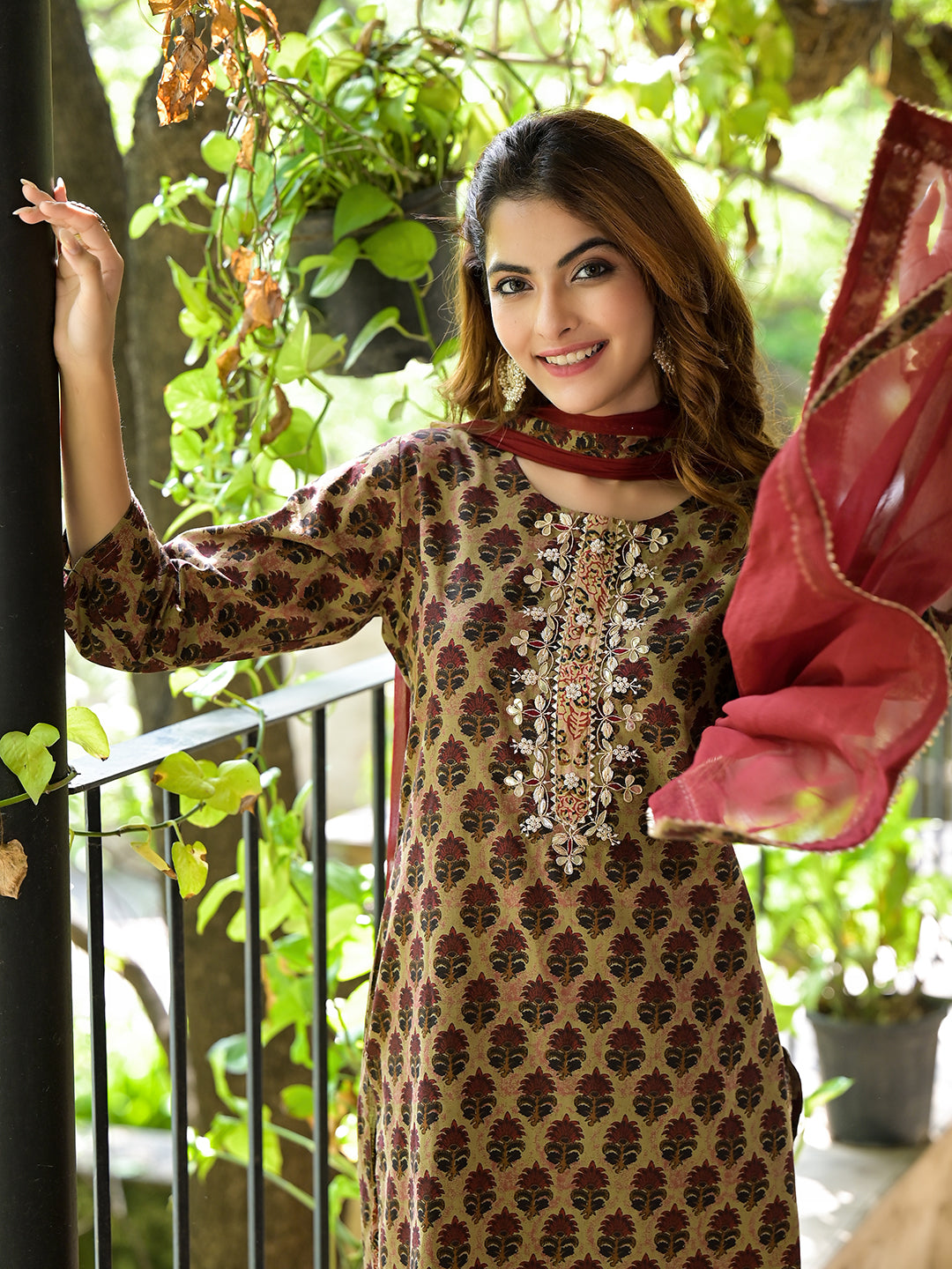 Woman in a Brown Straight Fit Zardozi Work Knee Long Cotton Kurta Set with Embroidery