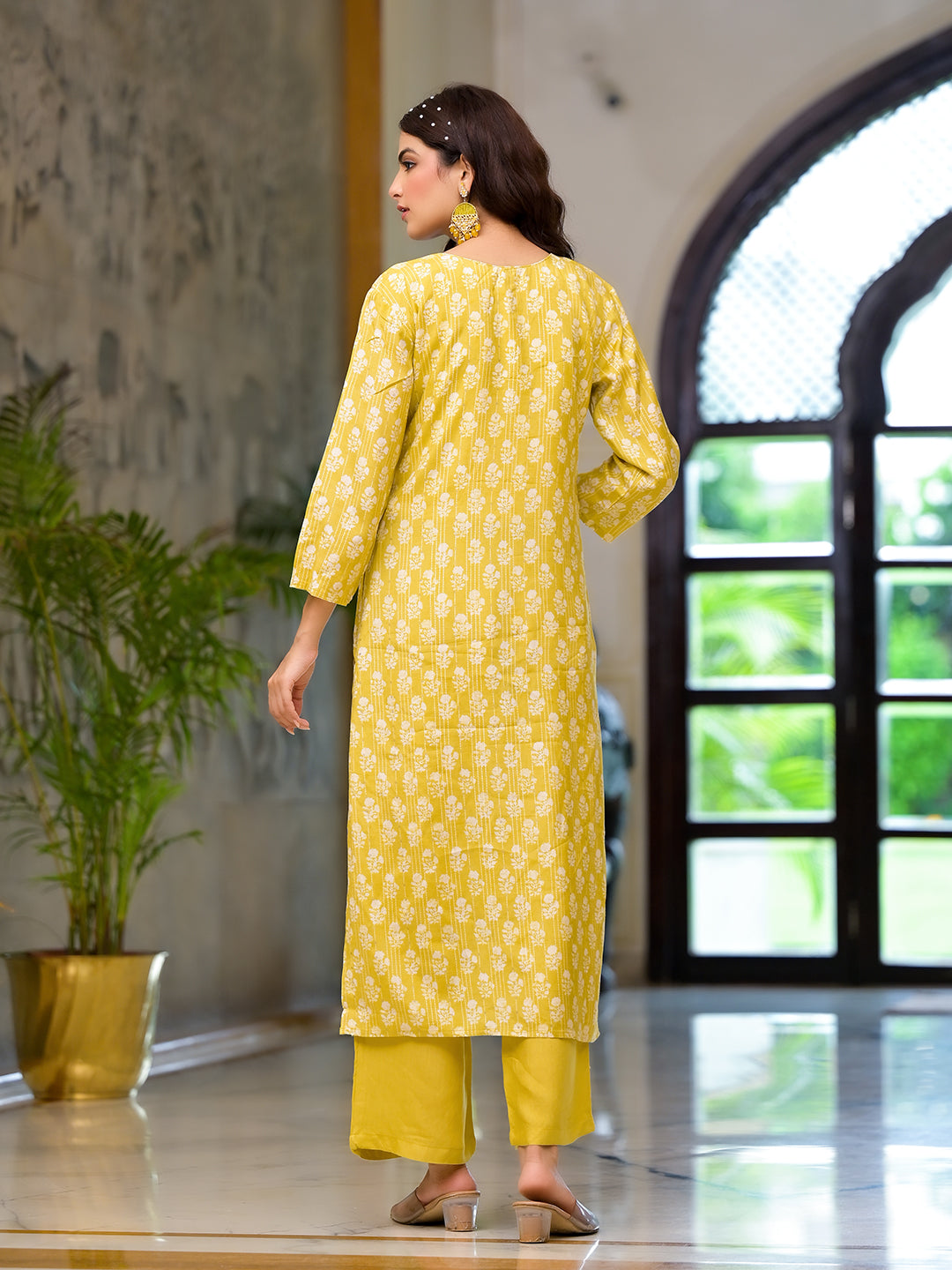 Yellow printed muslin straight kurta and trouser worn by a woman, showcasing the design