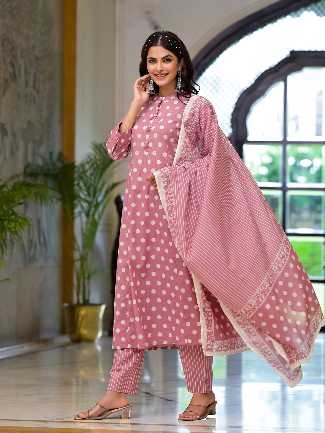 Woman in a light pink printed pure cotton straight kurta with matching dupatta