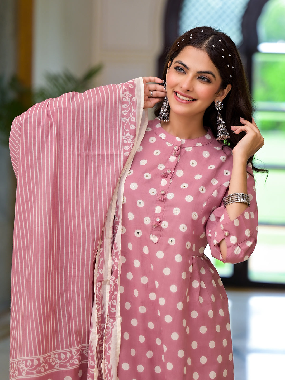 Woman in pink printed pure cotton straight kurta and shawl, smiling at the camera