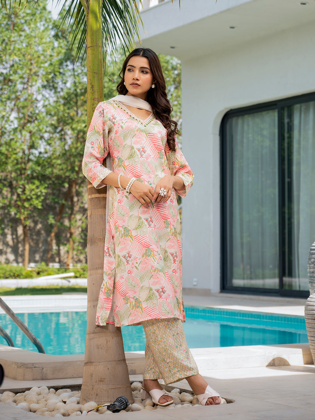 Woman wearing a Floral Print Muslin Kurta Set in pink and beige tones