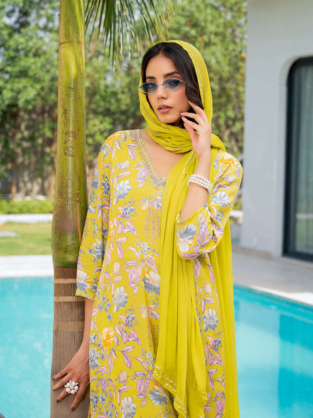 Woman in yellow embroidered floral print muslin kurta set with matching headscarf