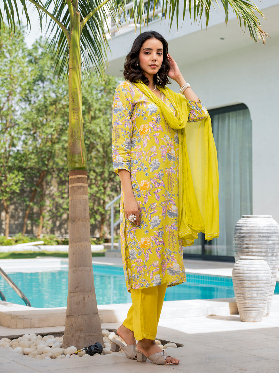 Woman in bright yellow embroidered floral print Muslin Kurta Set showcasing traditional style