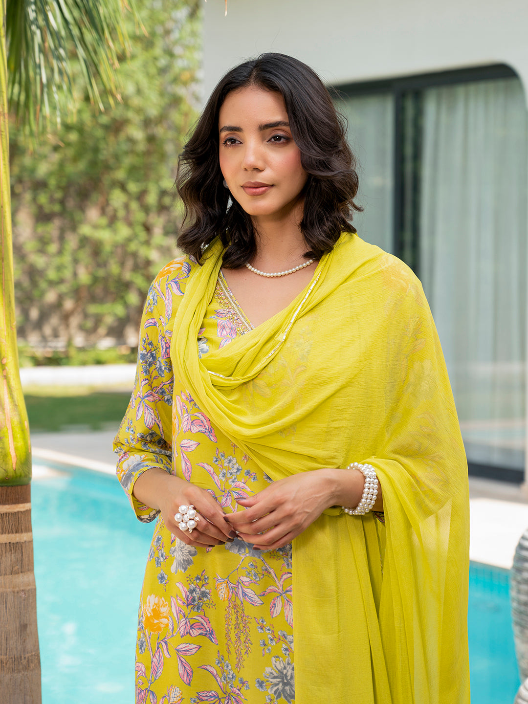 Woman in vibrant yellow embroidered floral print Muslin Kurta Set with draped scarf