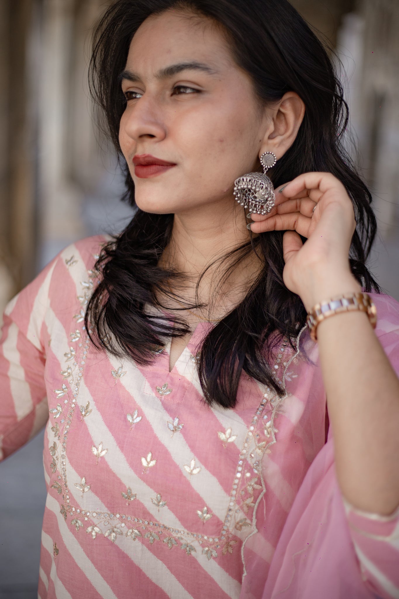 Woman showcasing Light Pink Leheriya Cotton Kurta with Organza Dupatta and stylish earrings